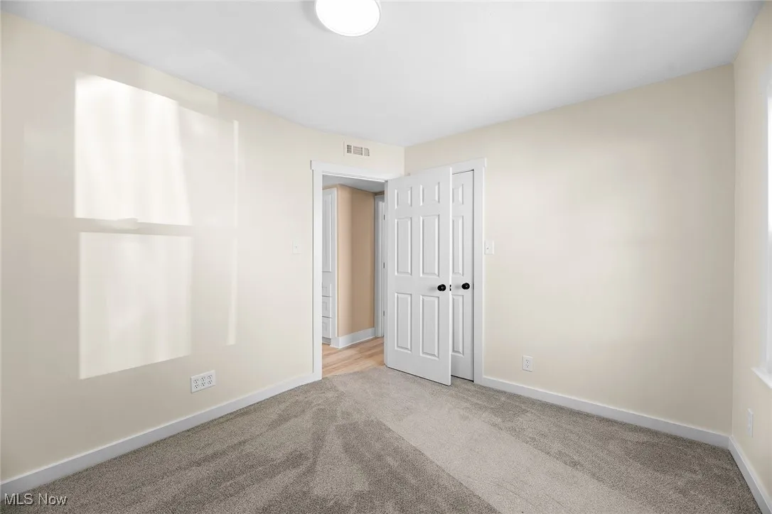 Unfurnished room featuring carpet flooring and baseboards