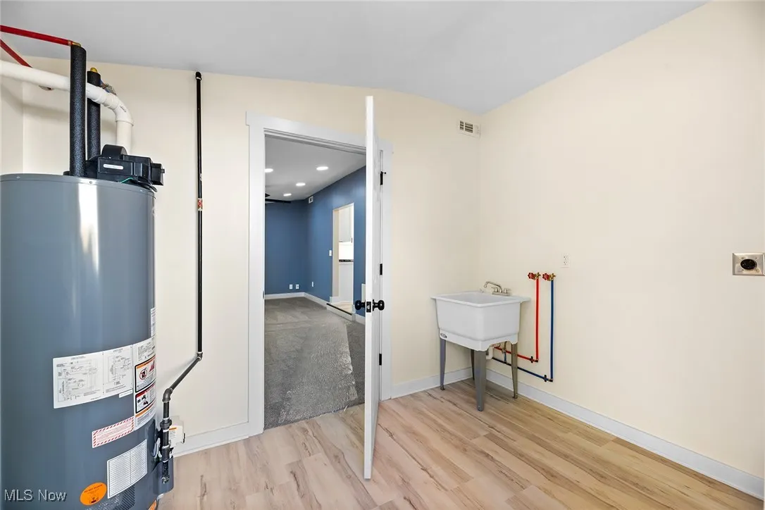 Utility room featuring gas water heater
