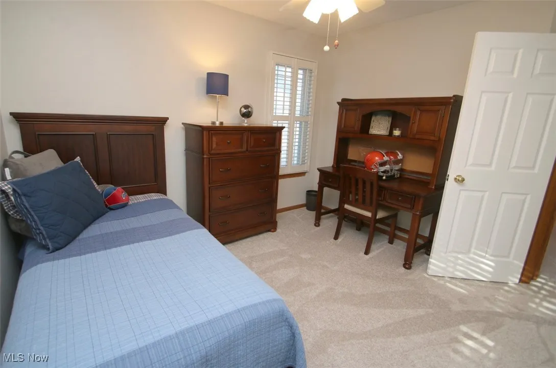 Bedroom featuring light carpet and ceiling fan