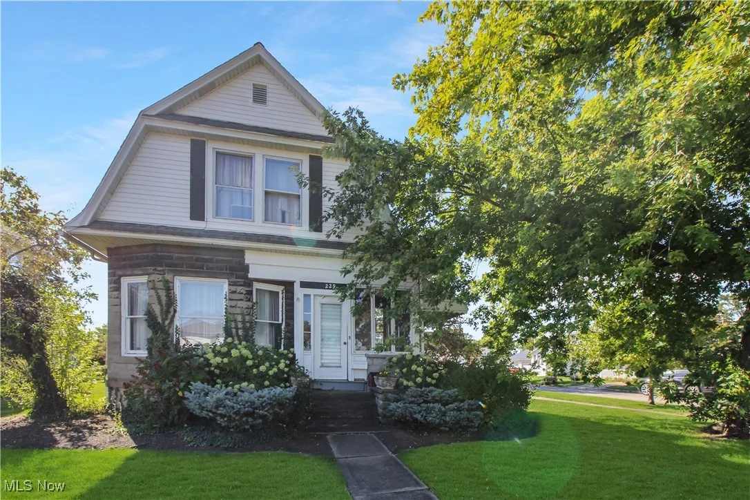 View of front of property with a front yard