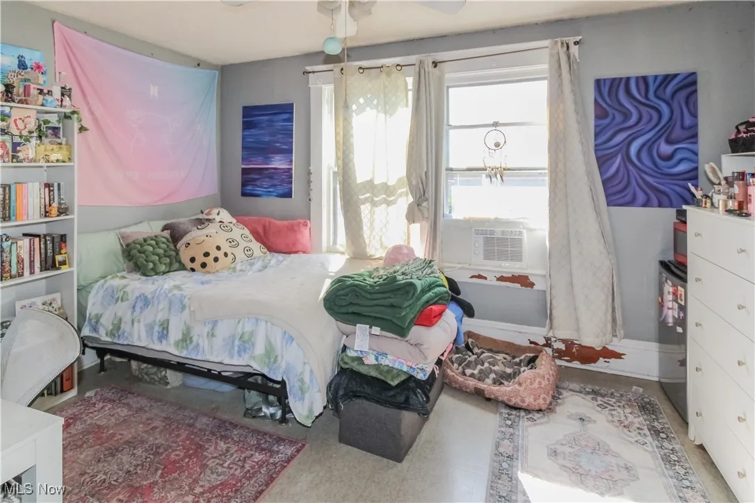 Bedroom featuring a ceiling fan and cooling unit