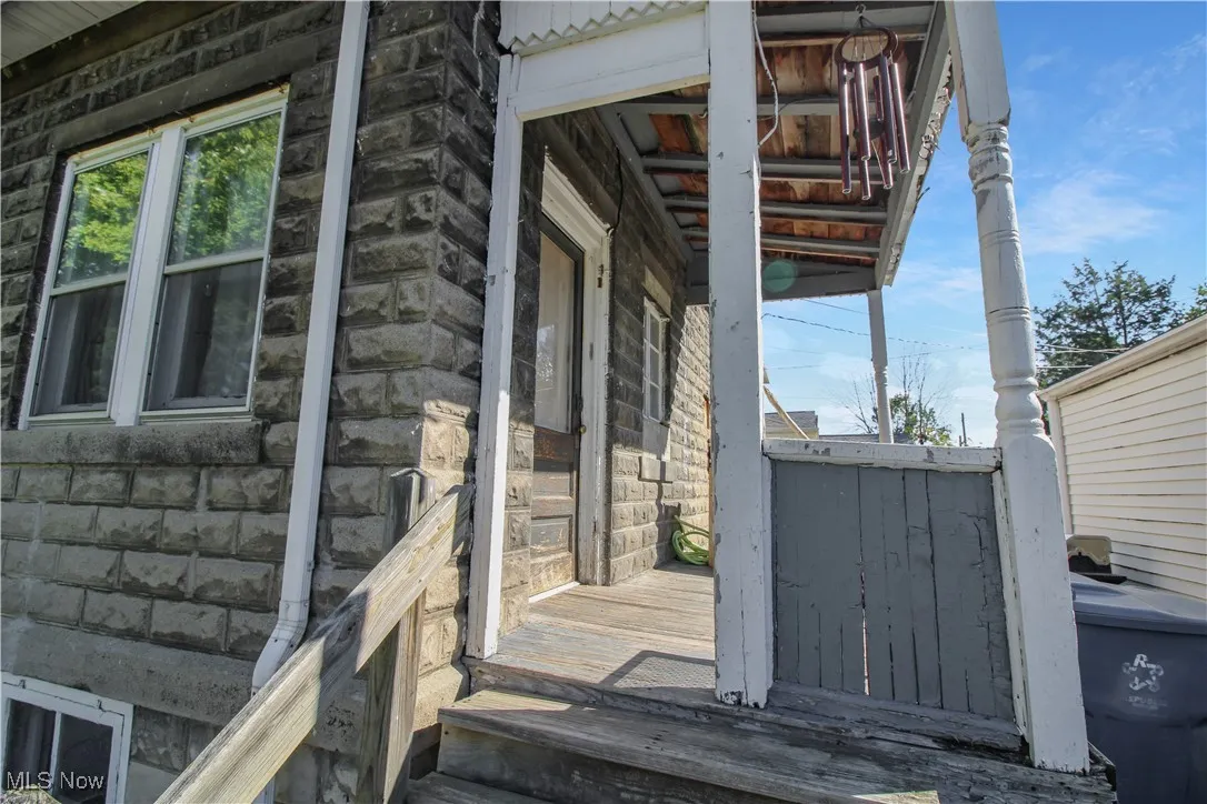 View of side of home featuring stone siding