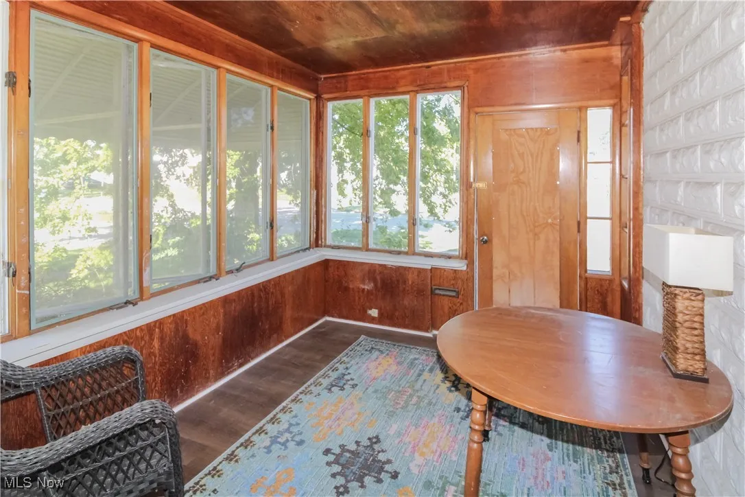 Sunroom / solarium with wooden walls and wood finished floors