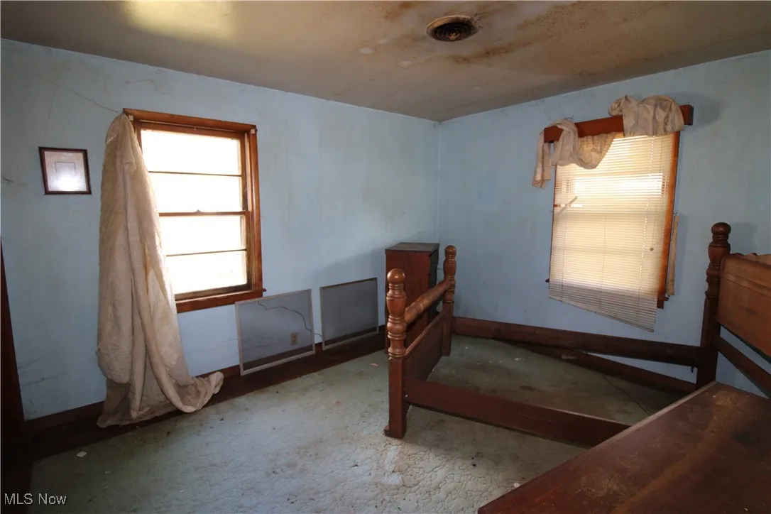 Bedroom with multiple windows