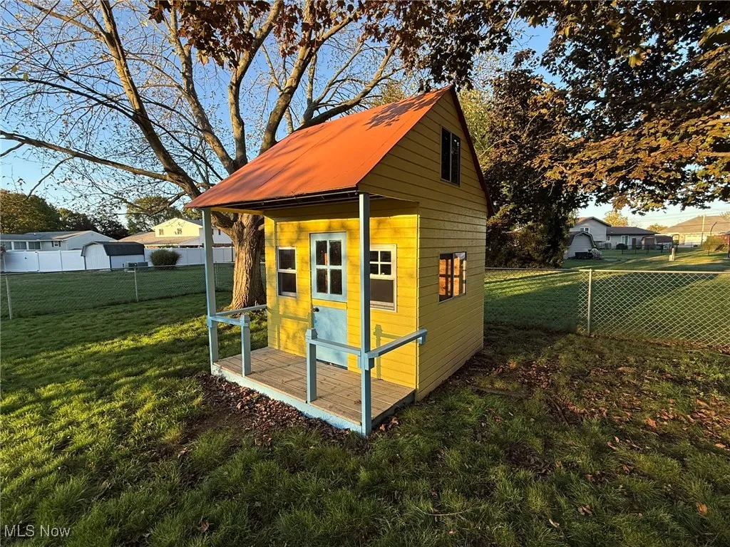 View of outdoor structure featuring a fenced backyard
