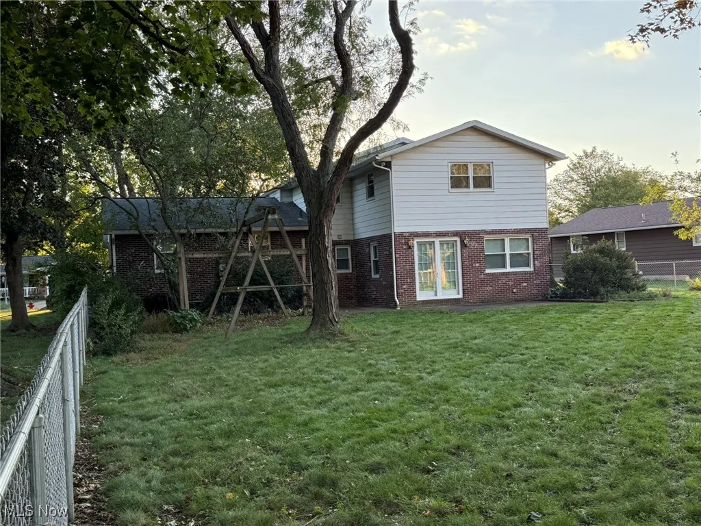 Rear view of property featuring brick siding