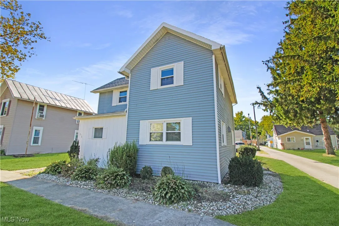 Rear view of property with a yard and board and batten siding