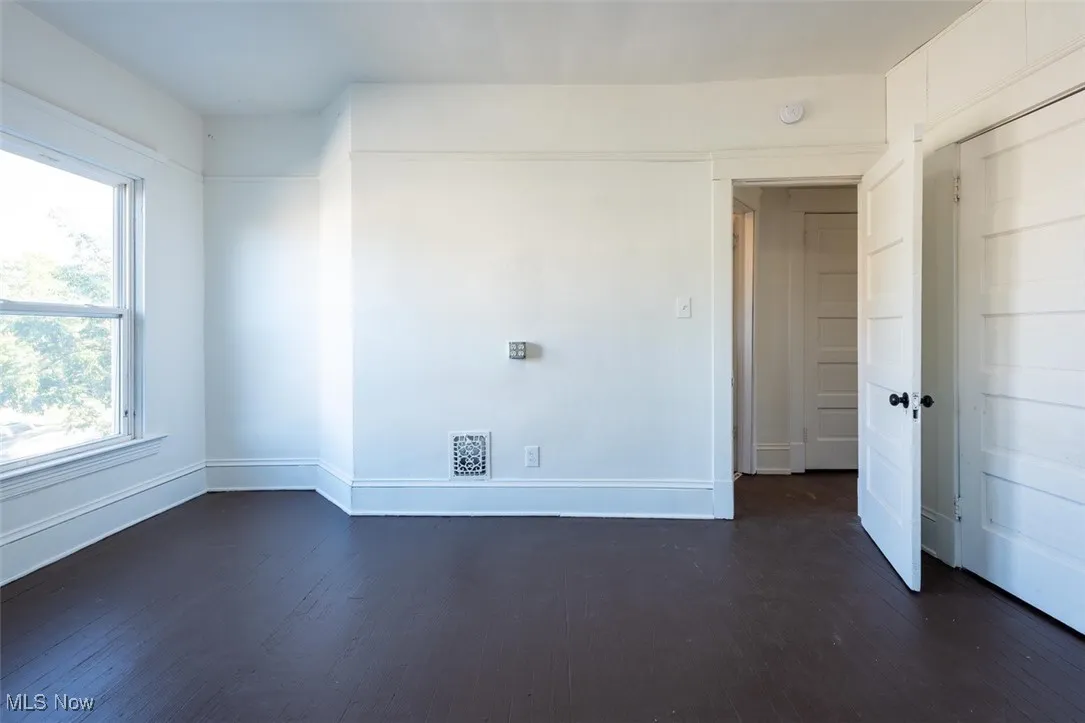 Unfurnished room with dark wood-style floors