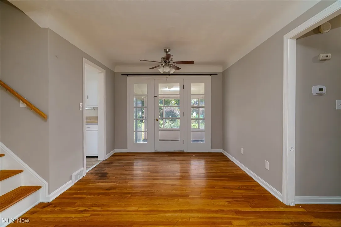 Foyer featuring stairway, light wood-type flooring, and ceiling fan