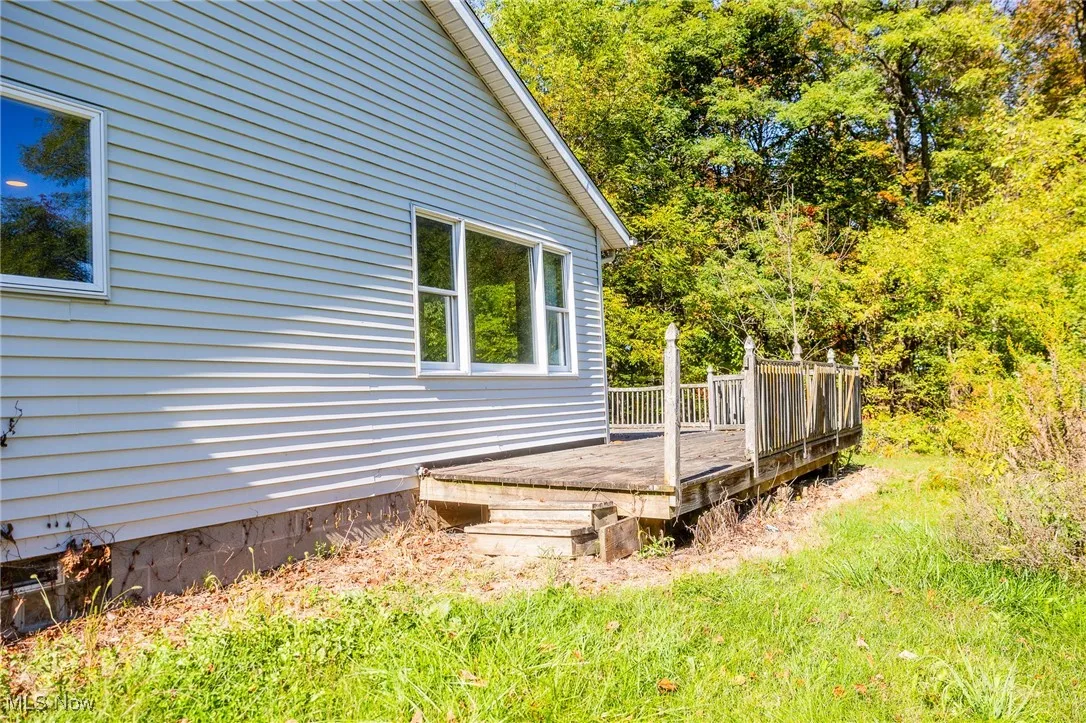 View of side of home featuring a deck