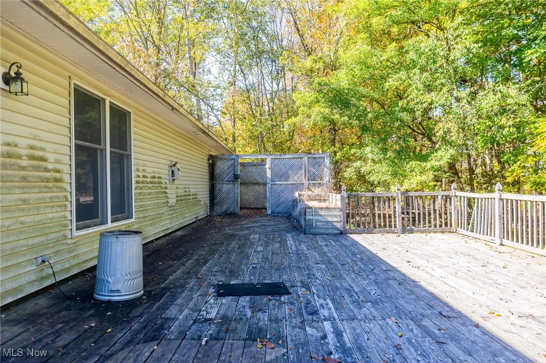 Wooden deck with view of wooded area
