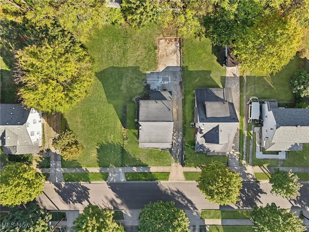 Aerial view of property and surrounding area with nearby suburban area