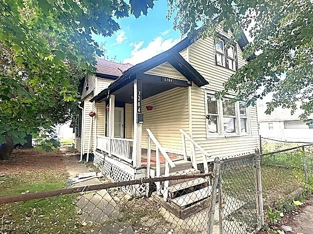 View of front of house featuring a gate and a porch