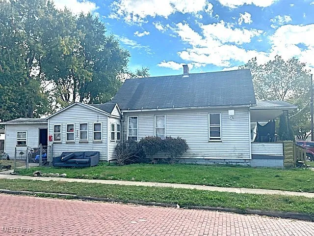 View of front of home featuring a front lawn and a chimney