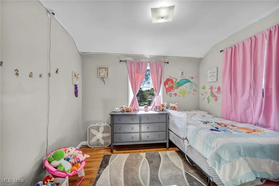 Bedroom featuring wood finished floors and baseboards