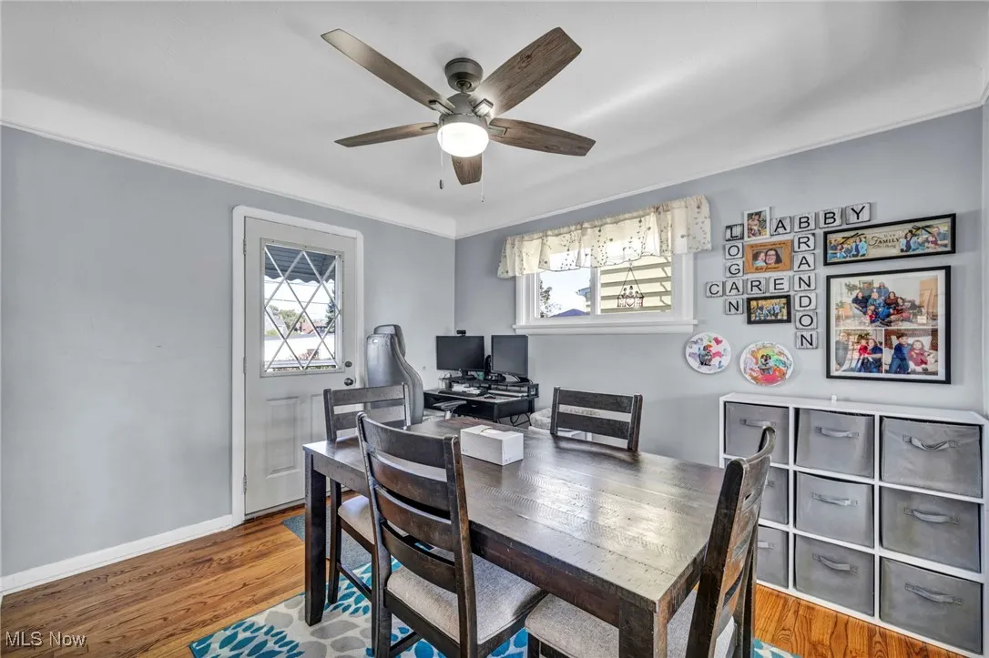 Office with wood finished floors, healthy amount of natural light, and ceiling fan