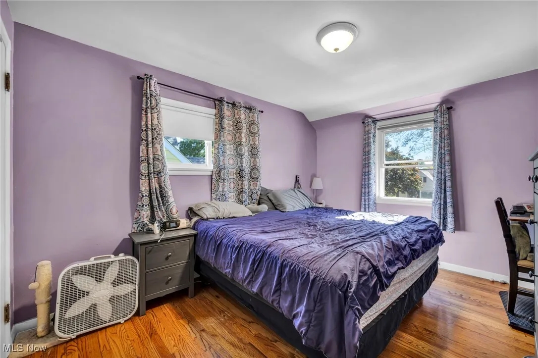 Bedroom with wood finished floors and baseboards