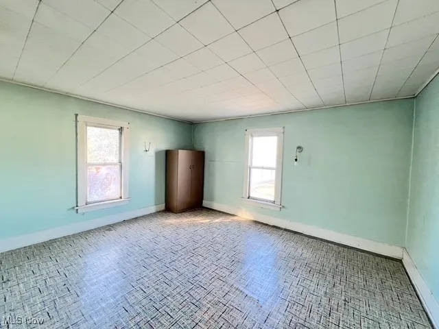 Unfurnished room featuring baseboards