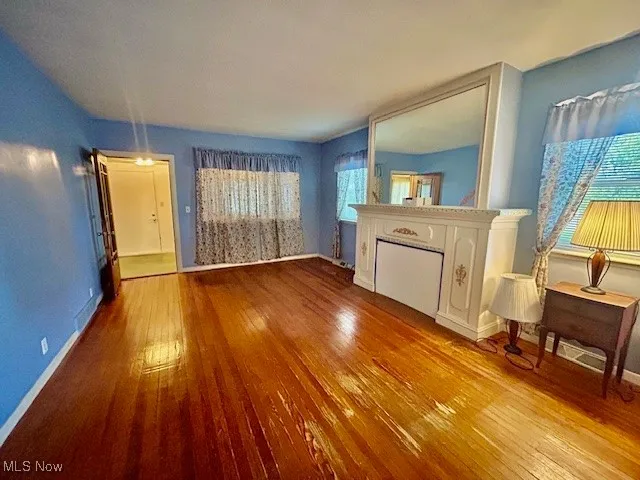 Unfurnished living room featuring light wood-type flooring