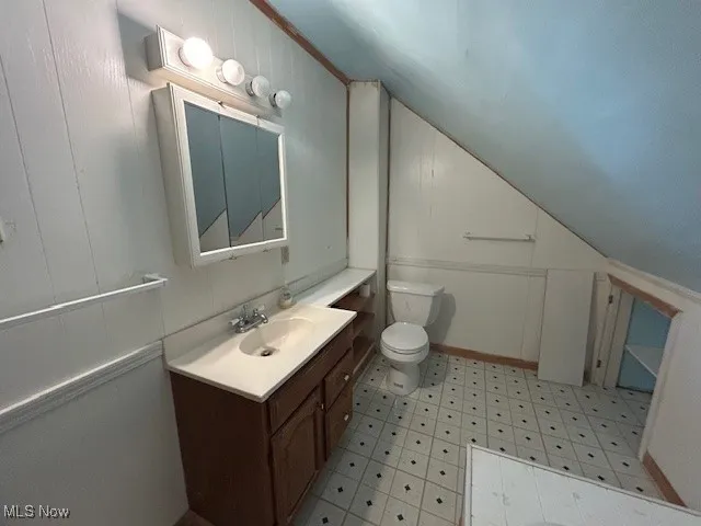 2nd floor Bathroom with light floors, vanity, lofted ceiling, and ornamental molding