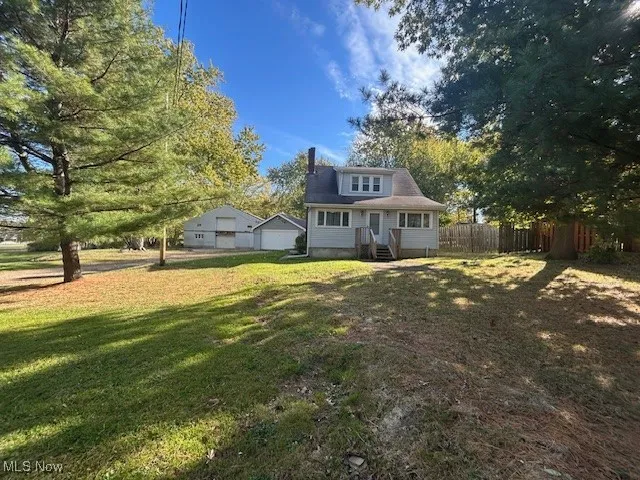 Front view of house with a deck and a chimney