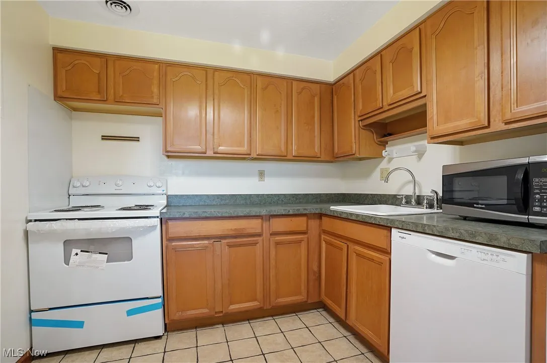 Kitchen featuring new stove, dishwasher, refrigerator