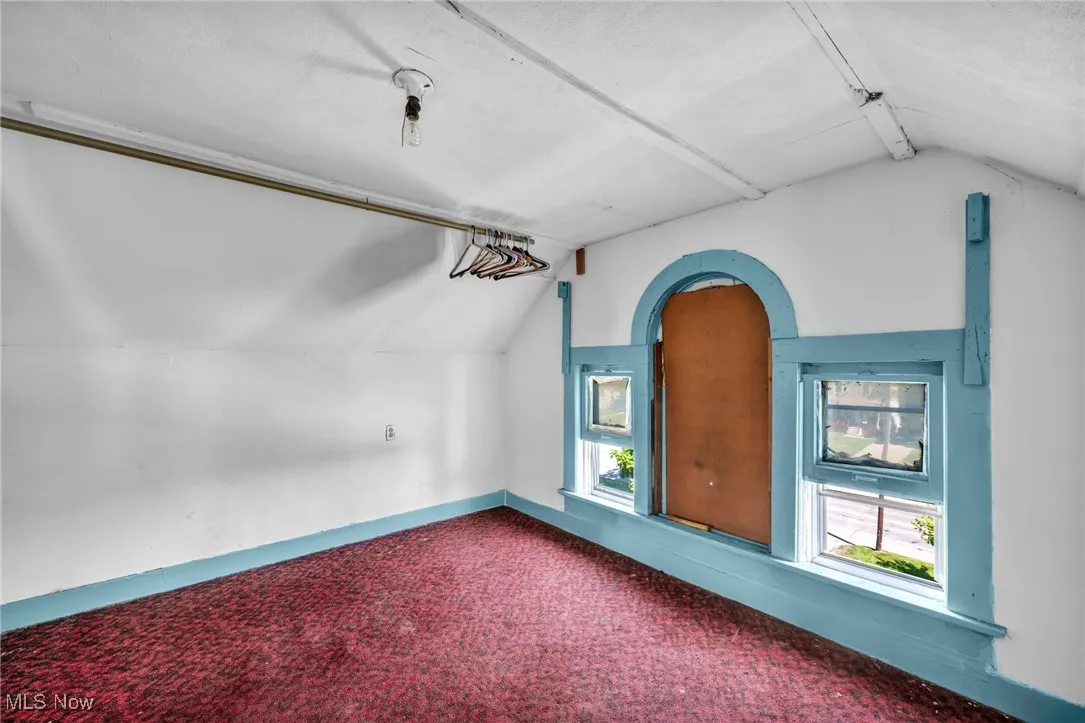 Additional living space featuring carpet flooring and baseboards
