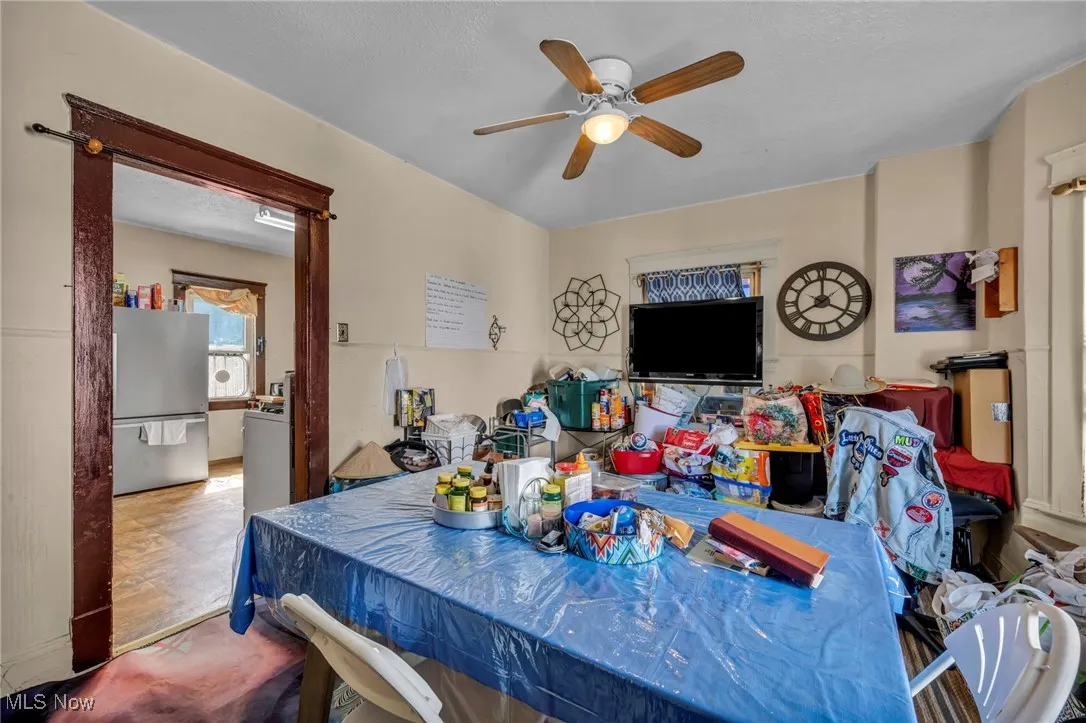 Dining room with a ceiling fan and a textured ceiling