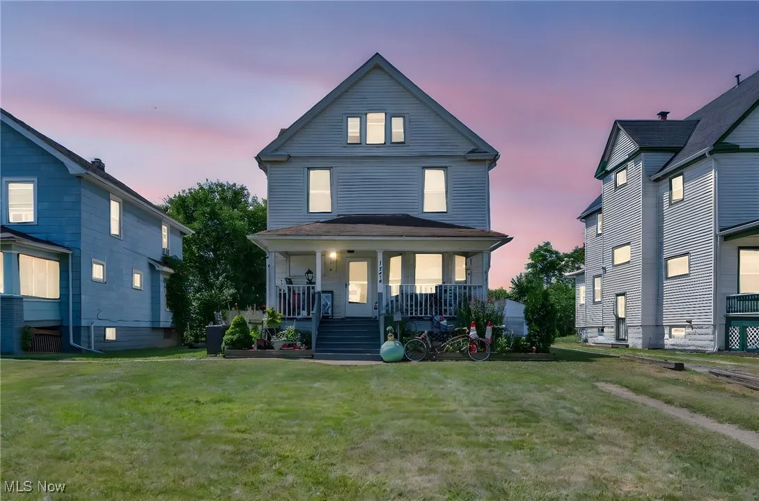 View of front of house featuring a porch and a lawn