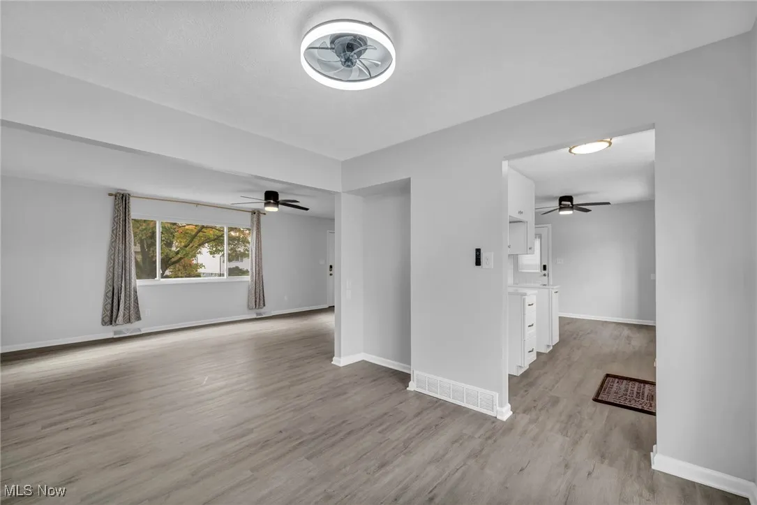 Empty room featuring light wood-type flooring and ceiling fan