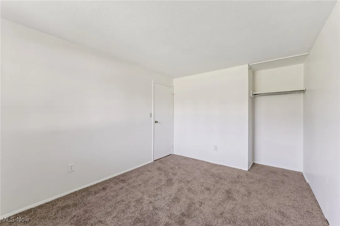 Unfurnished bedroom featuring carpet and a closet