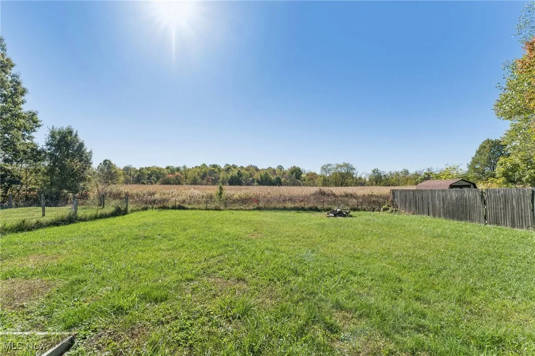 View of yard with a rural view