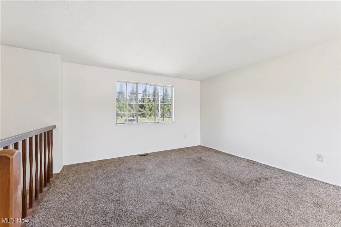 Spare room featuring carpet floors