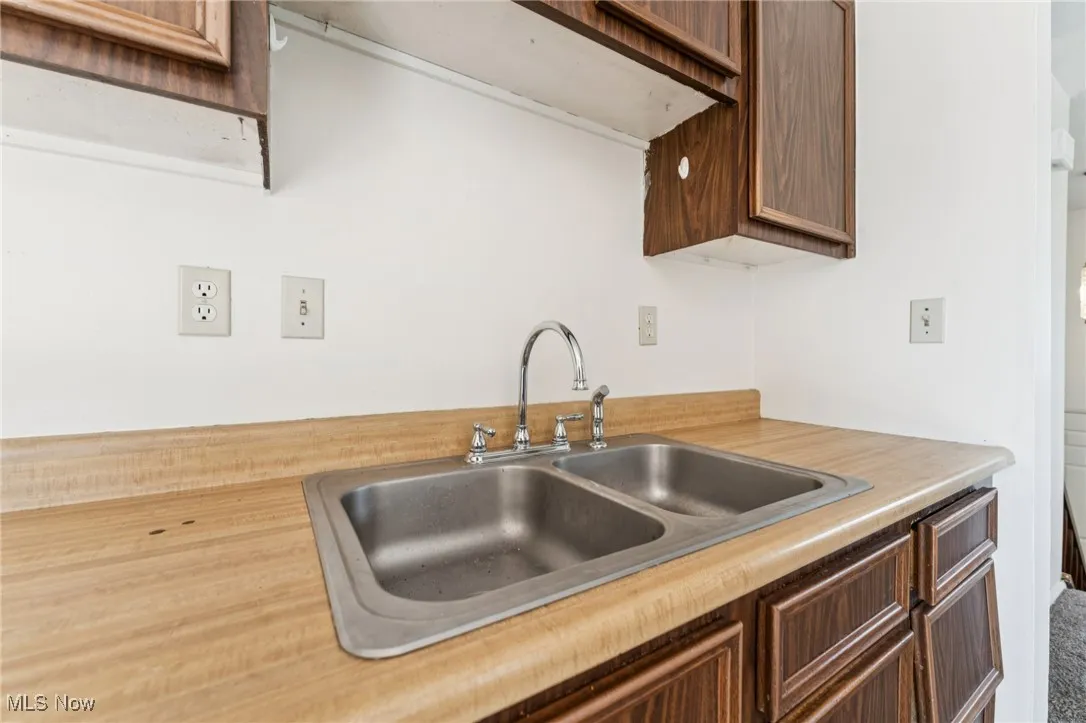 Kitchen with light countertops and brown cabinetry