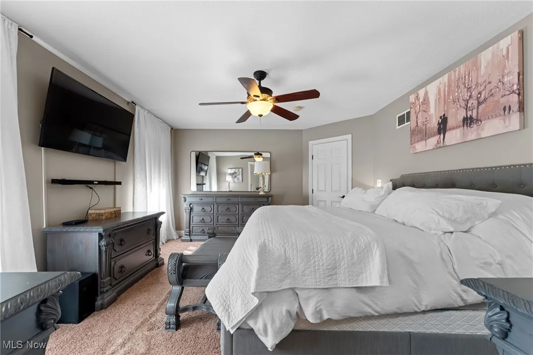 Bedroom with carpet and ceiling fan