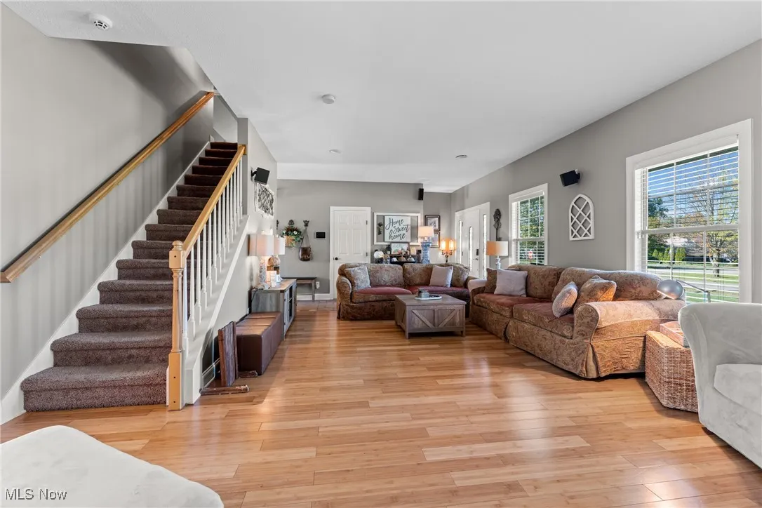 Living area with light wood floors and stairs