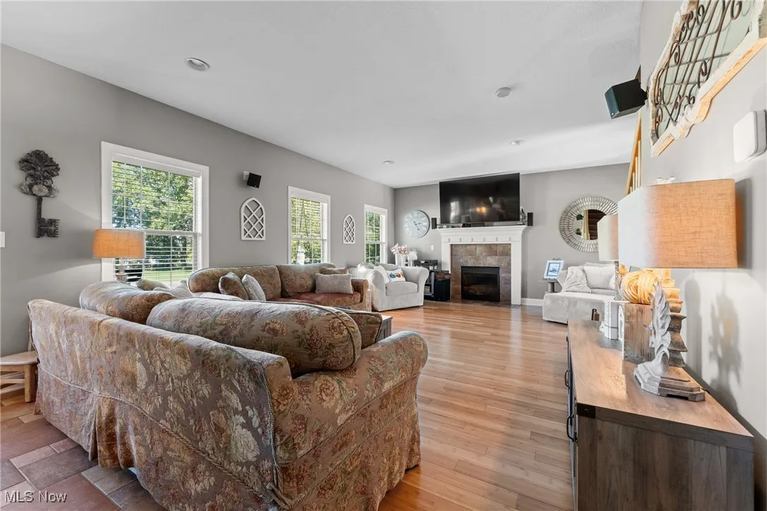 Living room with a tiled fireplace and light wood flooring