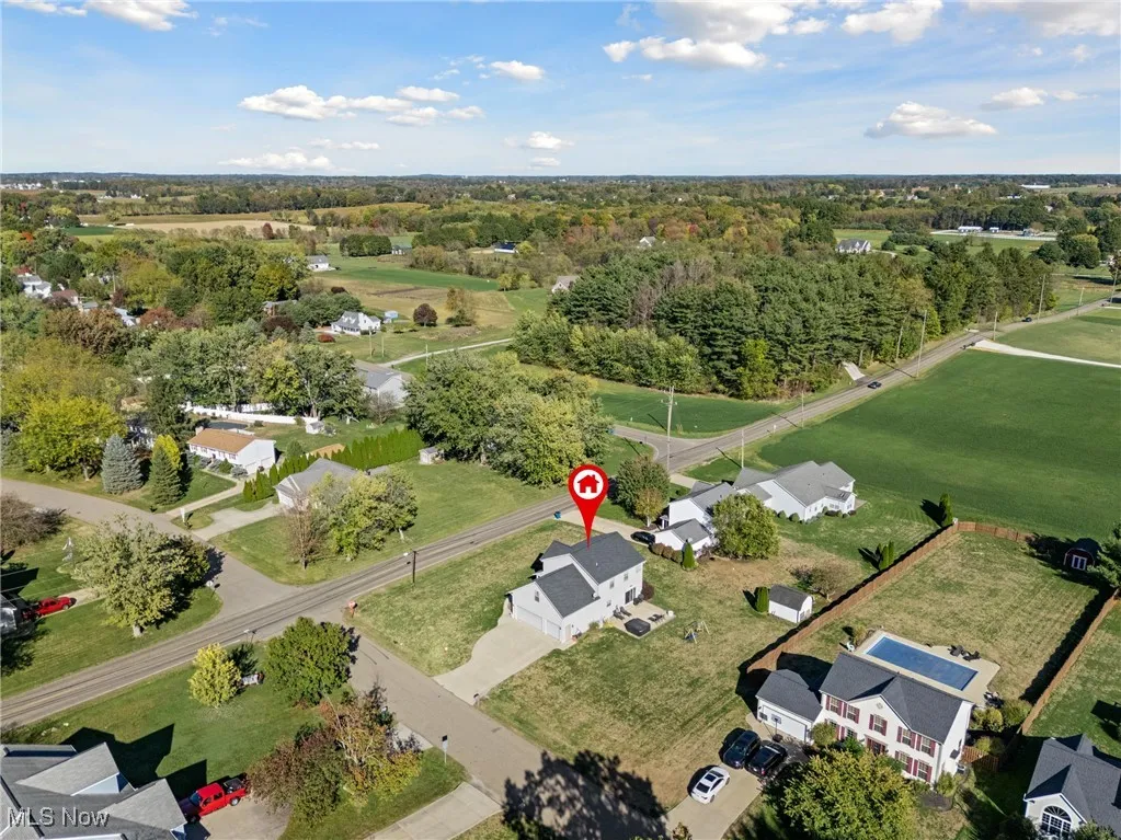 Aerial view of property's location with nearby suburban area