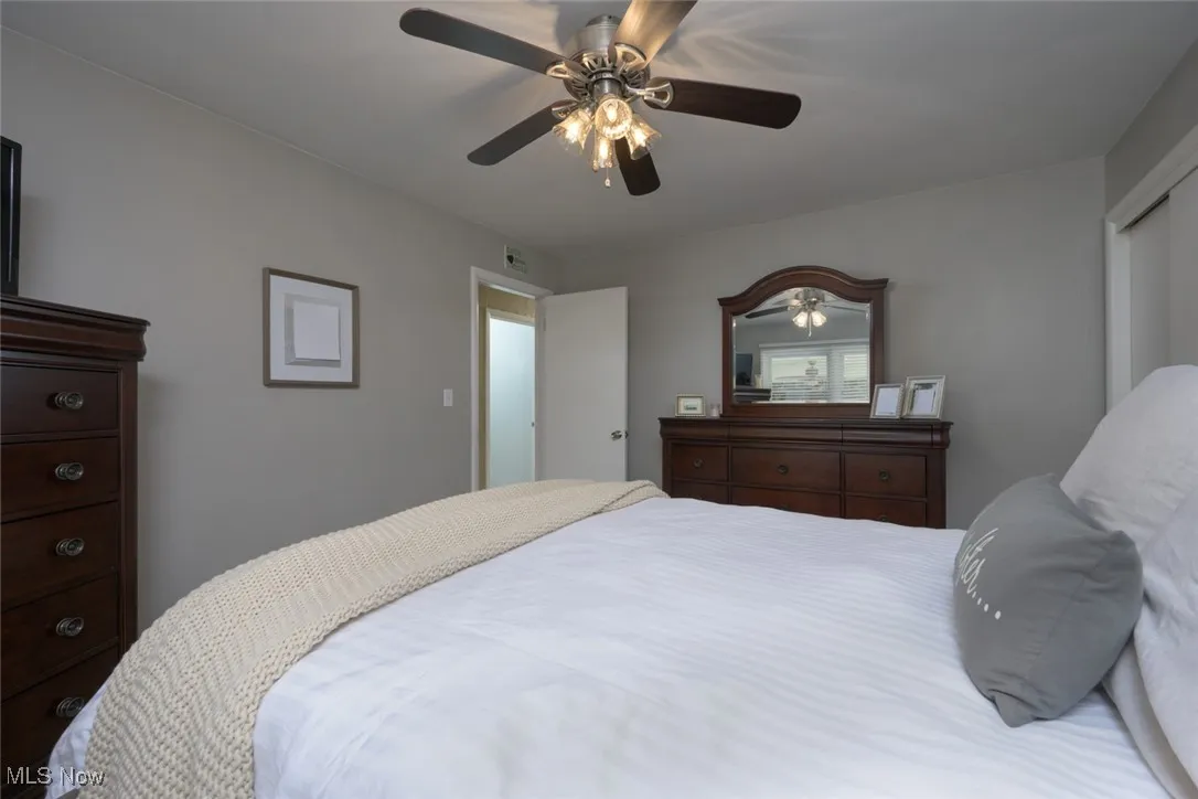 Bedroom with ceiling fan and a closet