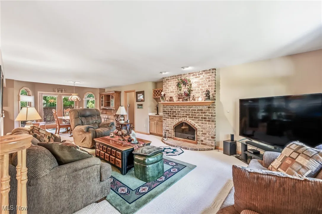 Living room with a fireplace and carpet flooring