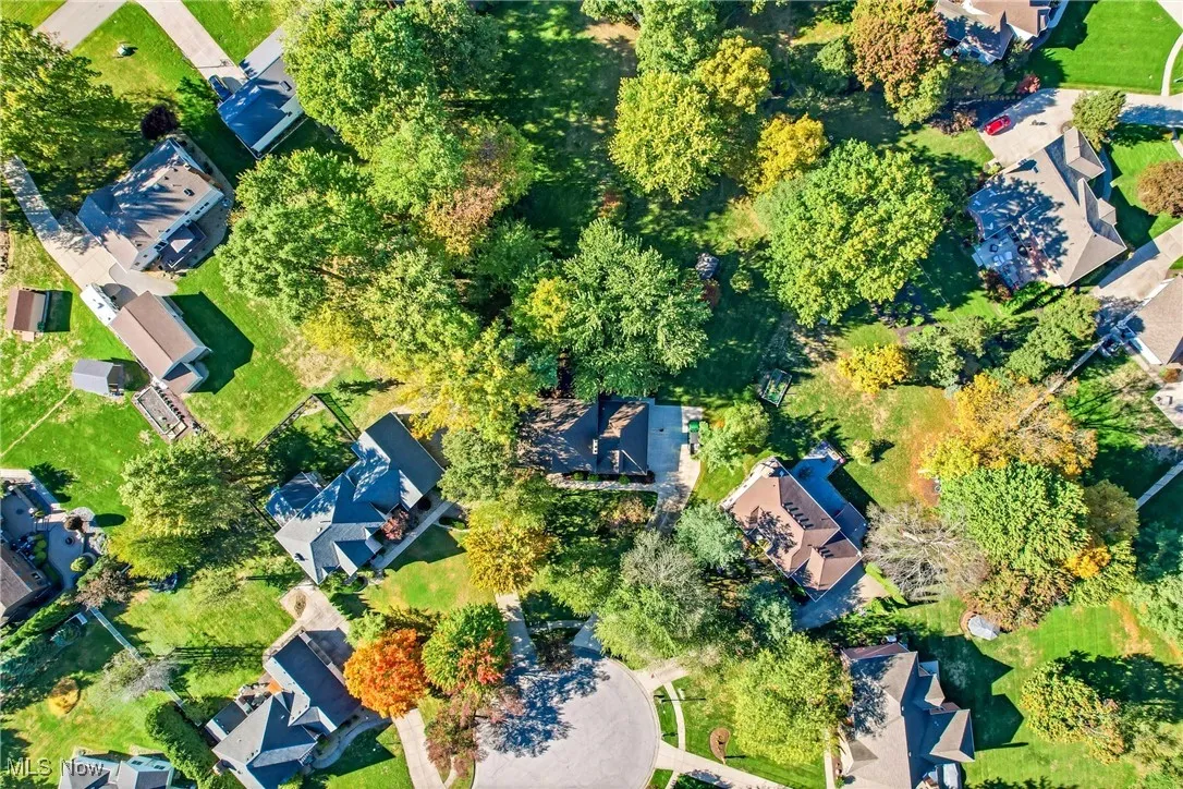Aerial view of property and surrounding area with nearby suburban area