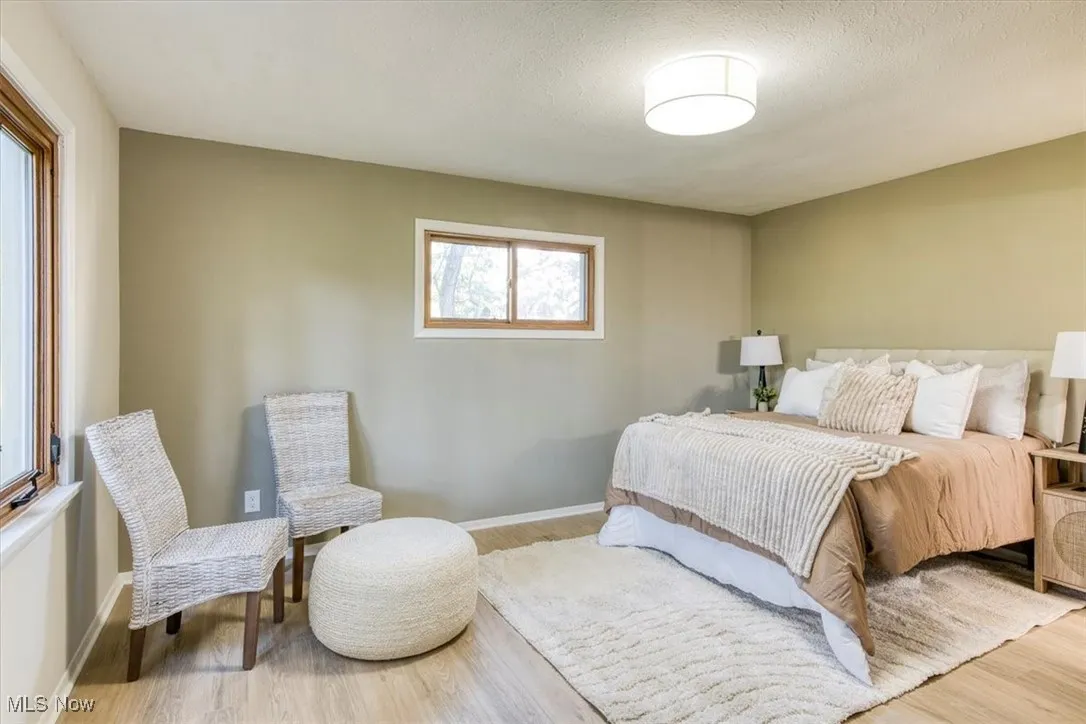 Bedroom featuring wood finished floors and a textured ceiling