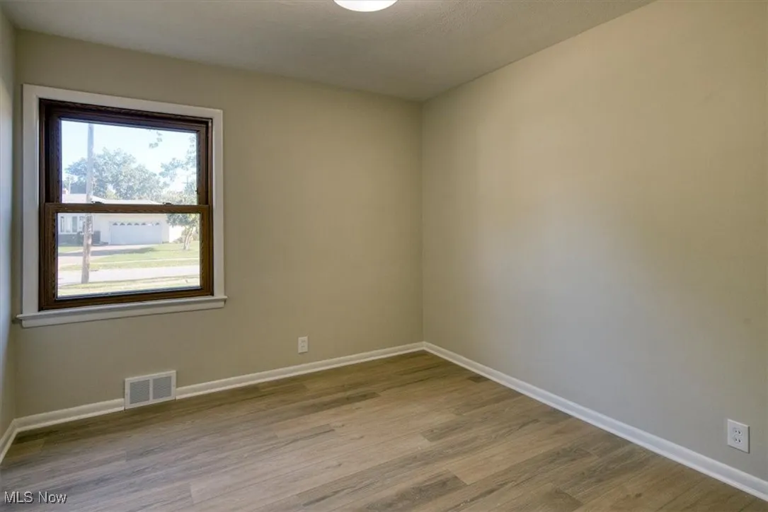 Spare room featuring light wood-style floors