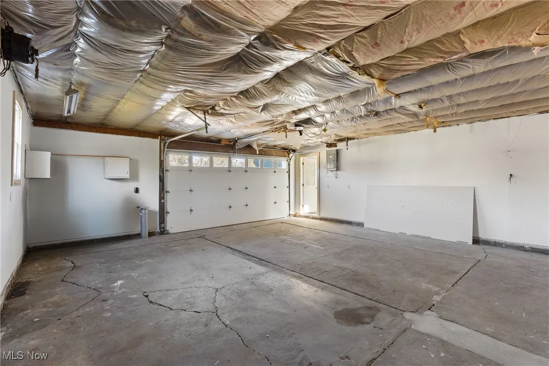 Garage featuring baseboards