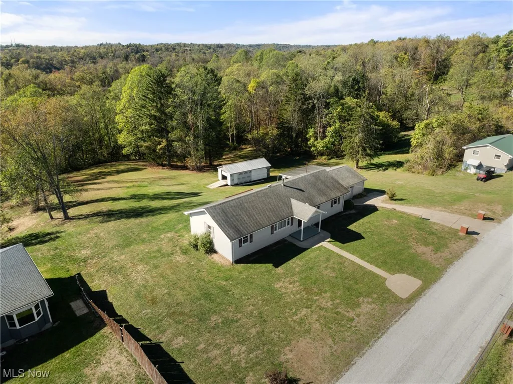 View of subject property with a forest