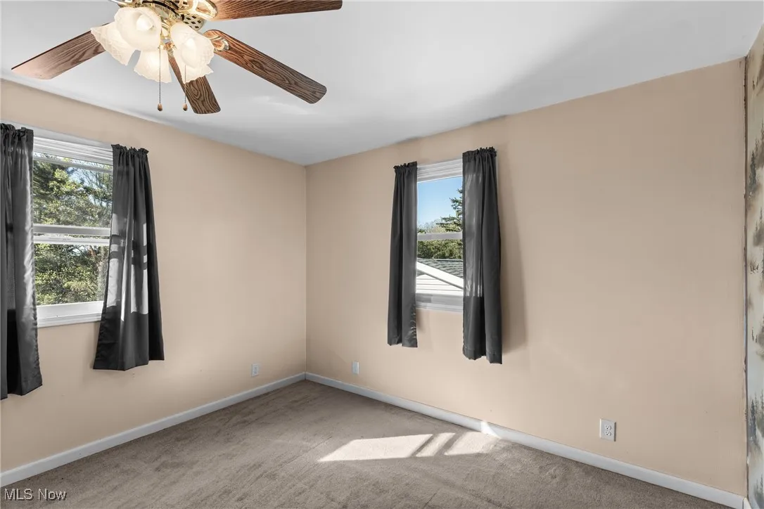 Empty room with carpet flooring and baseboards
