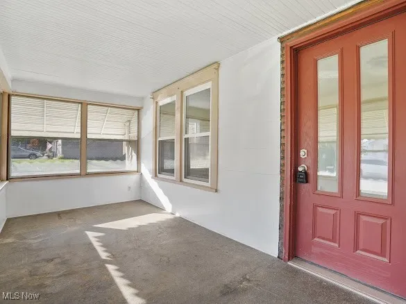 Unfurnished sunroom featuring carpet flooring