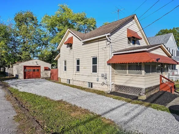 View of home's exterior featuring an outbuilding, driveway, and a detached garage