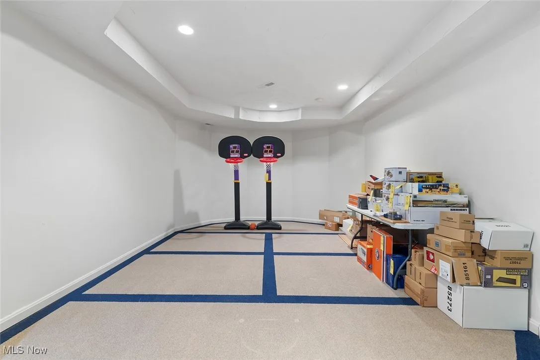 Finished below grade area featuring carpet floors and recessed lighting