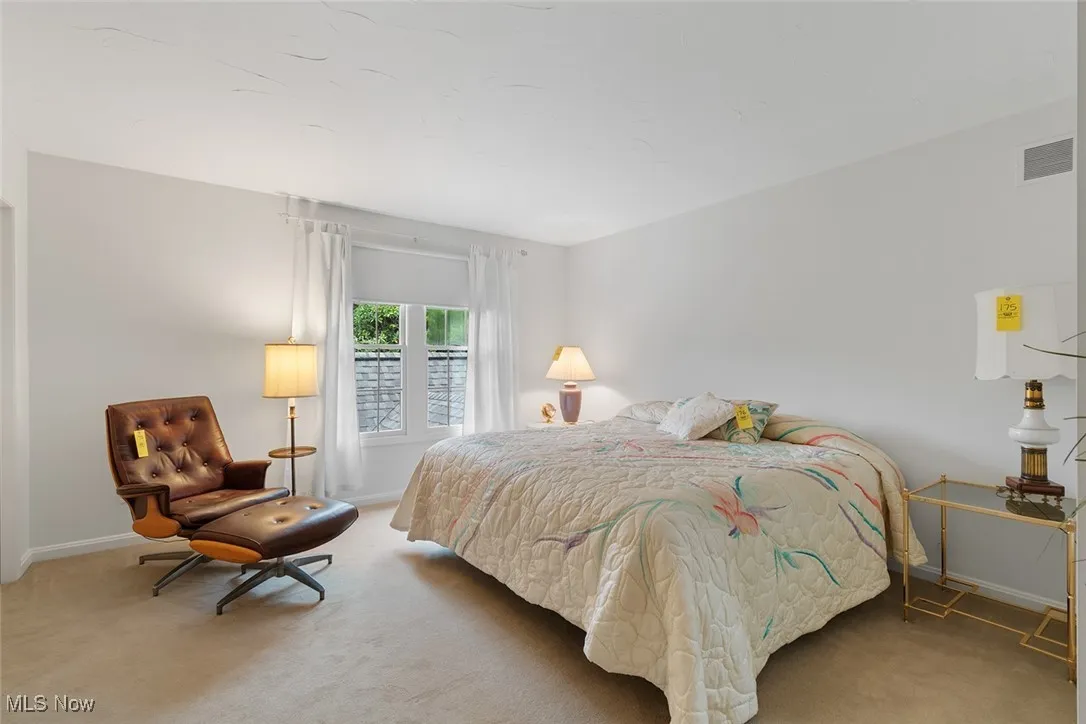 Bedroom featuring light colored carpet and baseboards